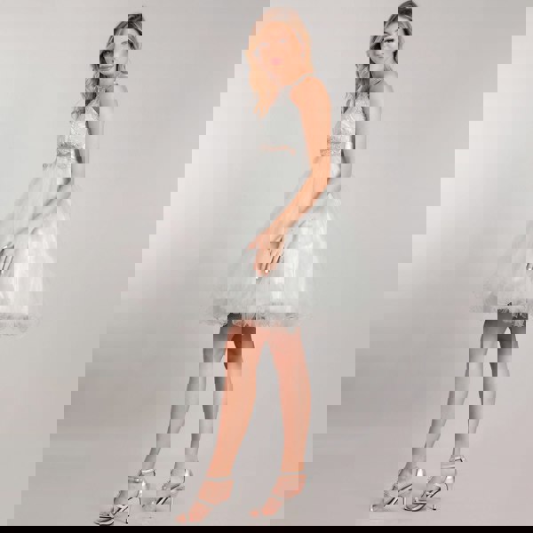 teenage model wearing a beaded halter neck dress from uk flower girl boutique