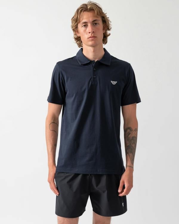 model wearing an Emporio Armani Mens Beach Polo with Eagle Logo in Armani Blue