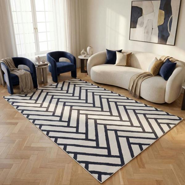 Living room with a chevron patterned rug, white sofa, and blue armchairs.