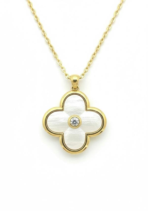 Gold necklace with a clover-shaped pendant on a white background