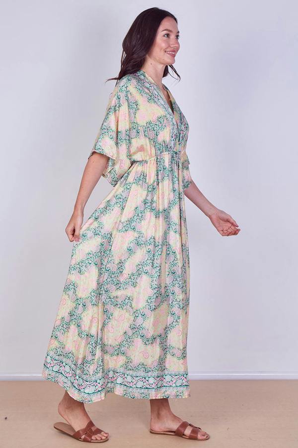 Woman wearing a floral dress on a plain background