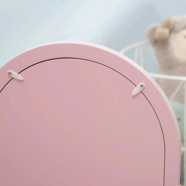 Pink arched mirror frame with rounded edge and metal corner hardware