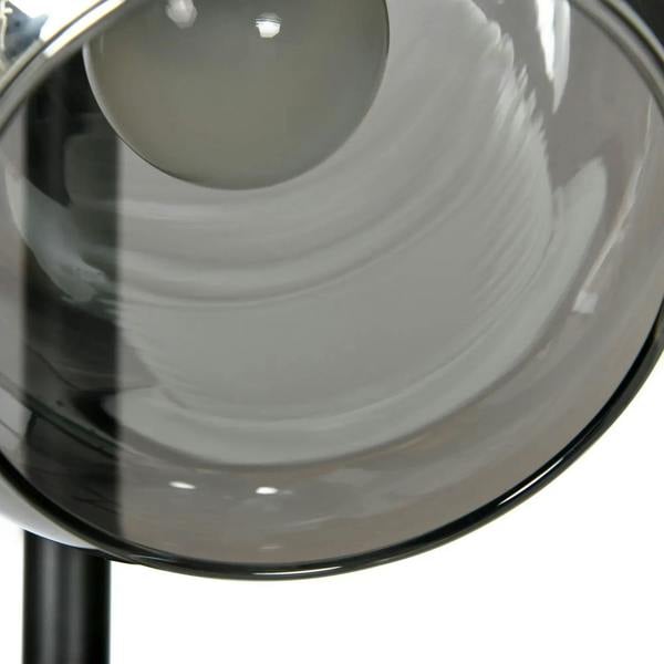 Close-up of clear glass globe shade on a grey floor lamp