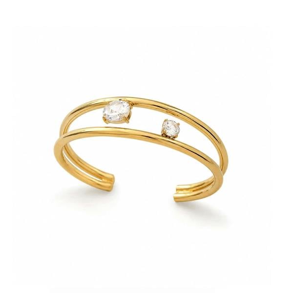 A gold open cuff ring featuring two small bezel-set clear stones, displayed on a clean white background.