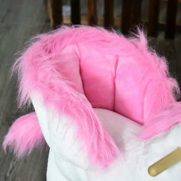 Plush unicorn rocking seat with pink backrest and white body, partial wooden rocker visible