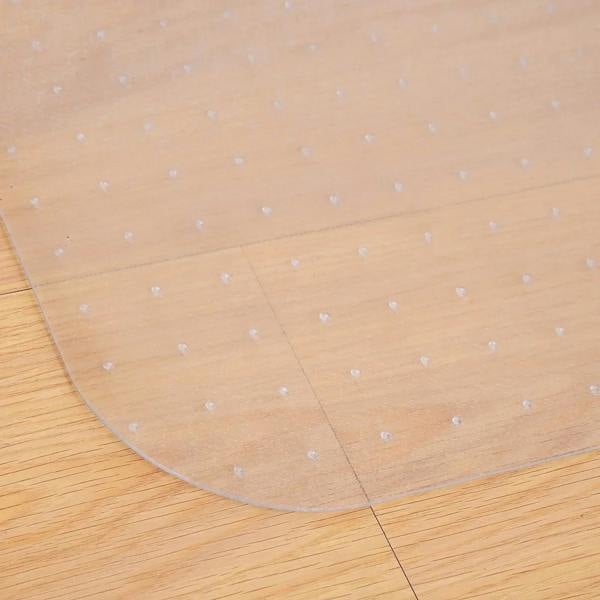Clear office chair mat on wood floor with raised non-slip studs