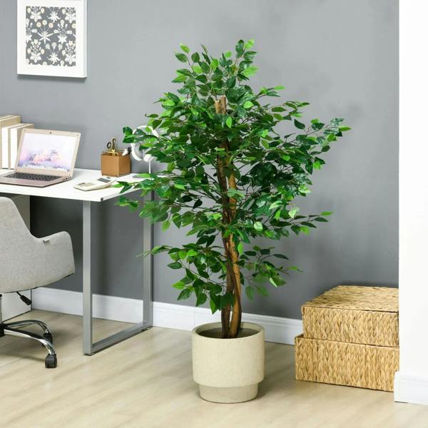 Green artificial ficus tree with natural trunk and light-colored pot