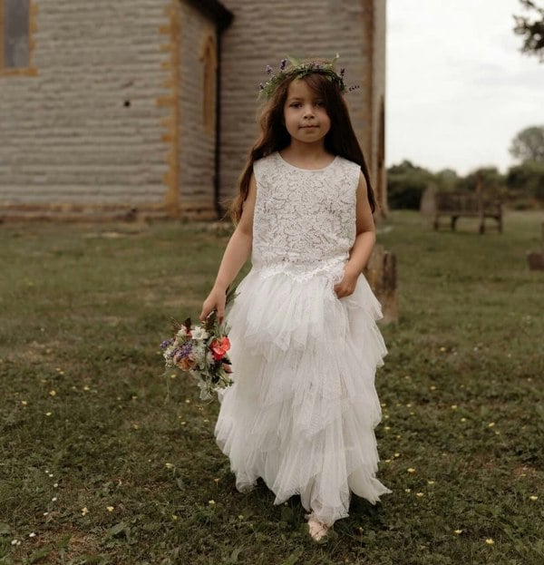 Young girl carrying flowers in church grounds