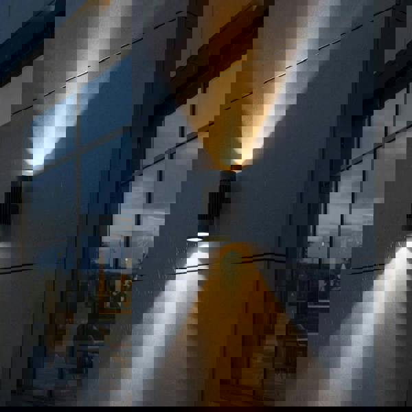 large exterior wall light mounted on the concrete wall of a commercial type building