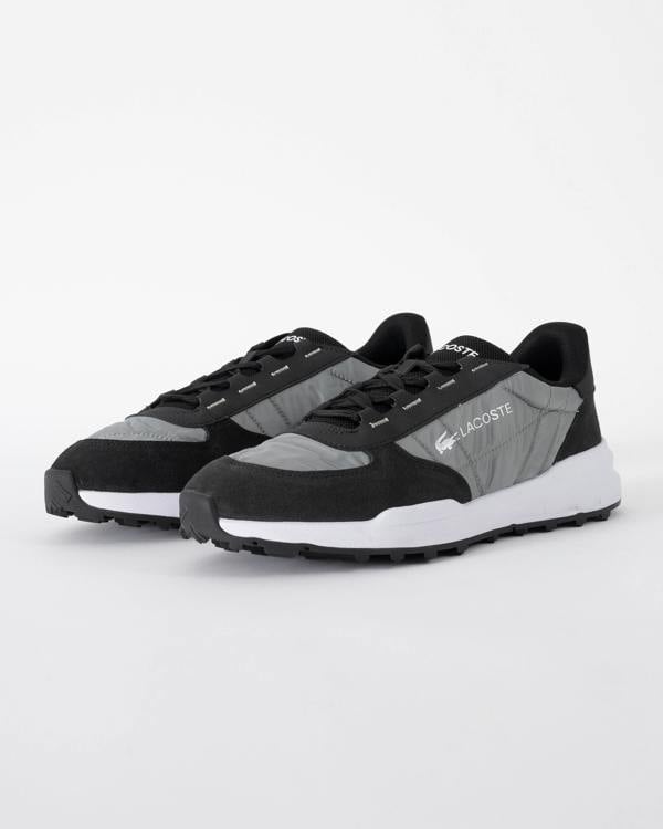 studio shot of Lacoste Elite Active Evo Mens Trainers in Black and White