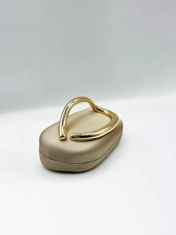 Oval Satin Hard Case Clutch Bag In Muted Gold - svnx