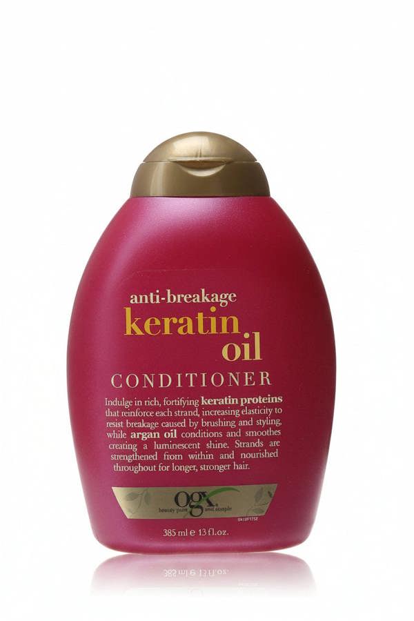 Red conditioner bottle with gold cap on a white background