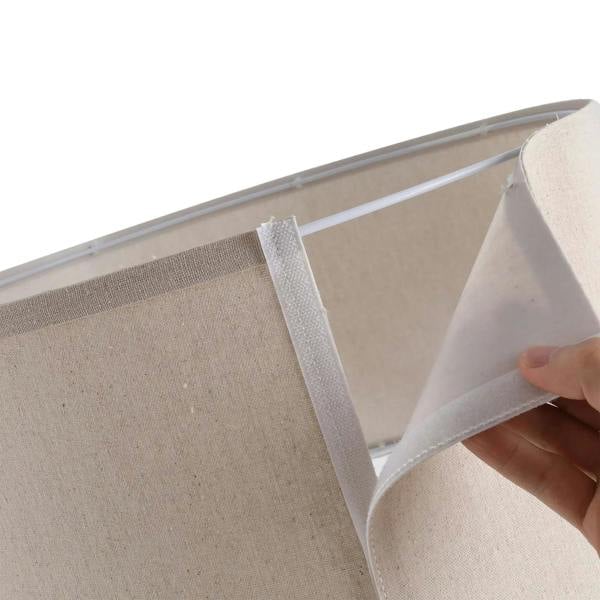 Close-up of beige lamp shade lining and seam detail with gray fabric edge trim