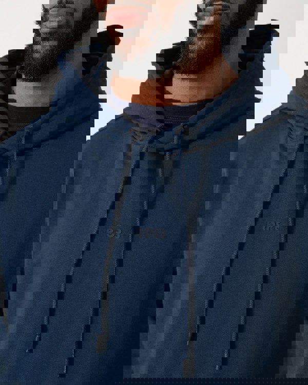 close up of a Model wearing a BOSS Orange WeSmallhood Mens Hoodie in Open Blue