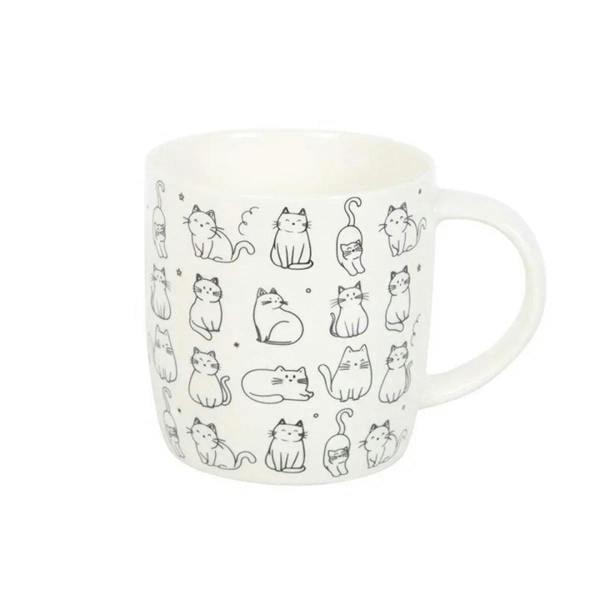 White ceramic mug with playful cat print, front angle showing handle and rounded body
