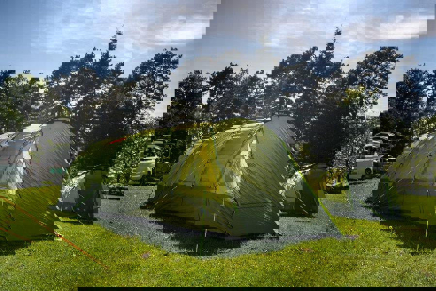 The Abberley XL 4 Berth Tent by OLPRO erected in a campsite with its doors closed.