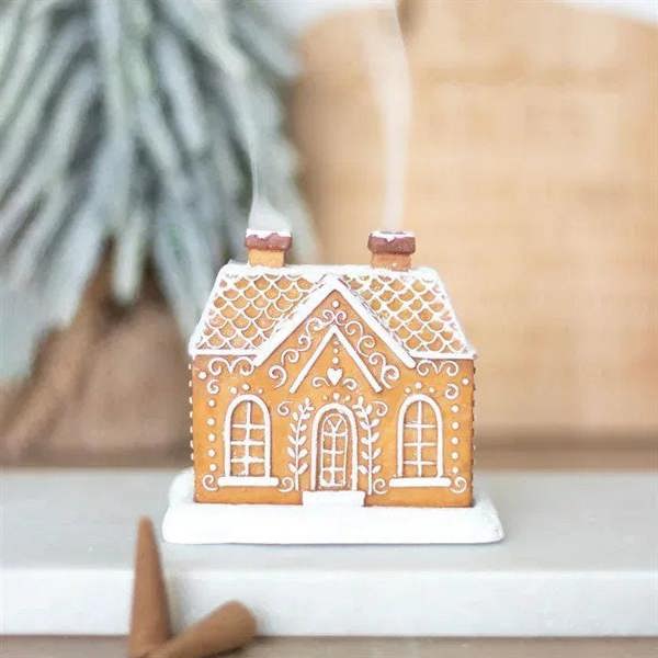 Gingerbread-style house incense cone burner on a white base with two chimneys
