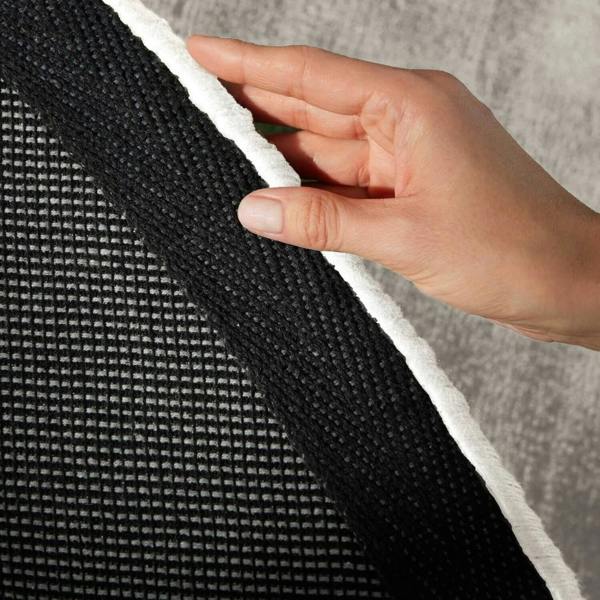 Hand holding a textured black and white fabric