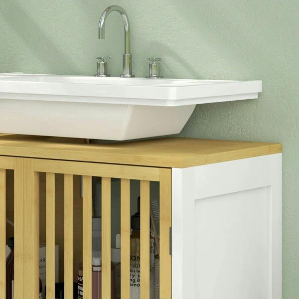 Corner view of white under-sink cabinet with bamboo slat front beneath sink