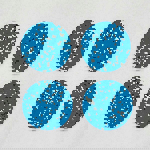 Set of 4 Recycled Round Plastic Coasters: Four round, blue and black splatter coasters on a white surface.