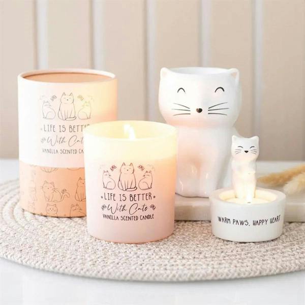 White ceramic cat oil burner with face design and lit tealight in holder