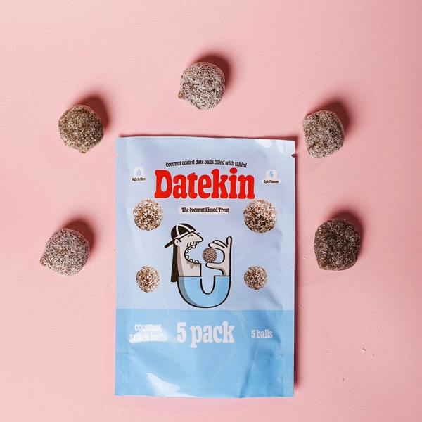 Datekin coconut date balls packaging with five date balls on a pink background
