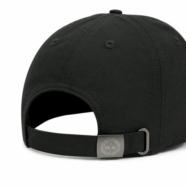 Black Marshall Artist nylon ripstop cap featuring an adjustable metal buckle strap with branded logo detailing.