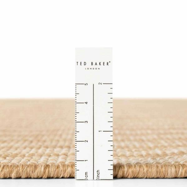 Beige fabric with a ruler and 'Ted Baker London' label on a white background