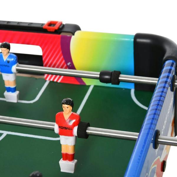 Foosball-style game table close-up with red and blue player figures and rods