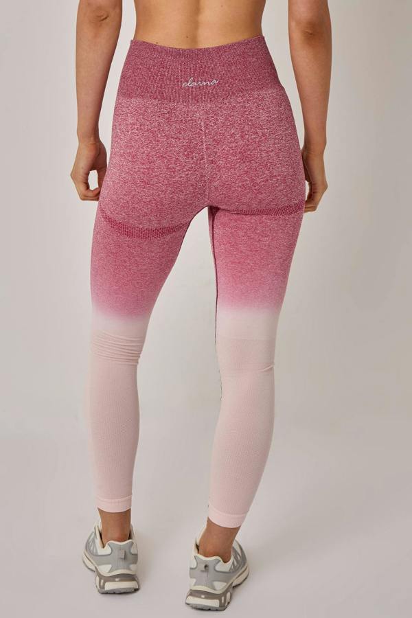 Pink and purple gradient leggings worn by a person on a plain background