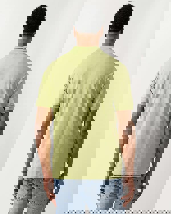 back shot of a model wearing a Lacoste Classic Fit L.12.12 Mens Short Sleeve Polo Shirt in Birch UYB