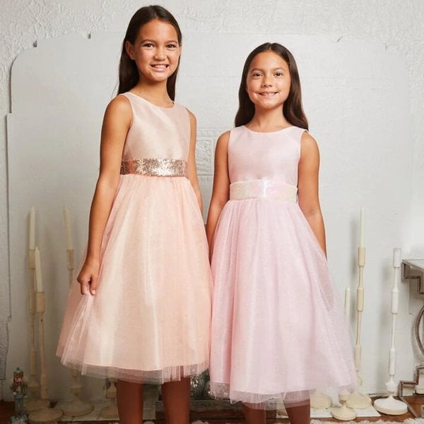 2 dresses in blush and baby pink worn together