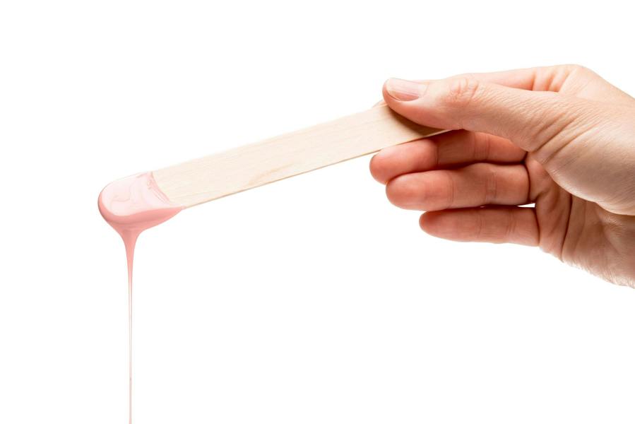melted rose wax dripping off spatula