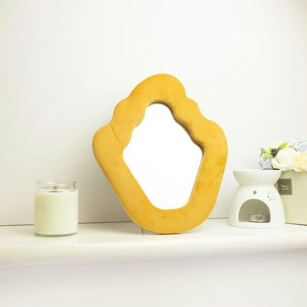Marigold soft flame-shaped mirror with open center, freestanding display