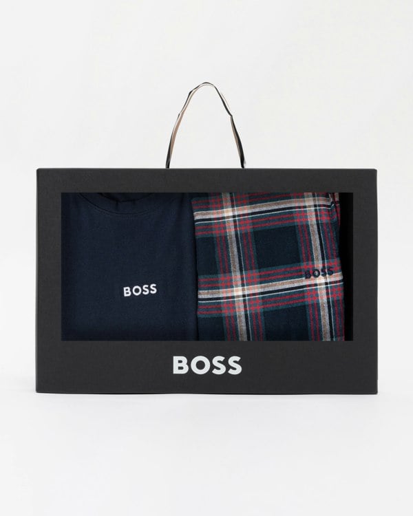 BOSS branded box with navy shirt and plaid pants on a white background