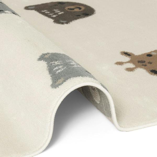 Close-up of a children's rug with bear illustrations on a white background