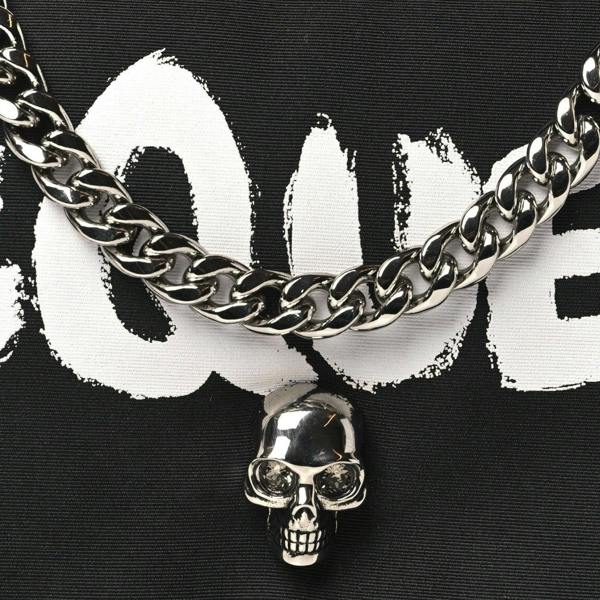Supplied Fashion nylon crossbody bag featuring a silver skull charm and chain detail on a black and white print