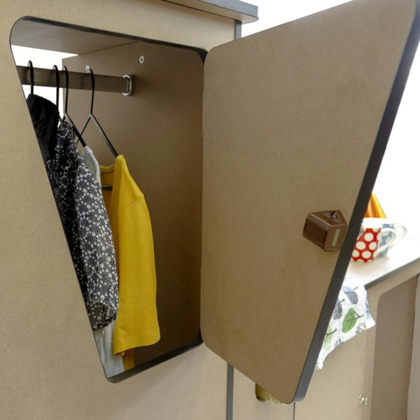 MDF Camper Van Kitchen Unit LHD with a triangular door, showcasing hanging clothes and a stylish, modern design in natural wood finish