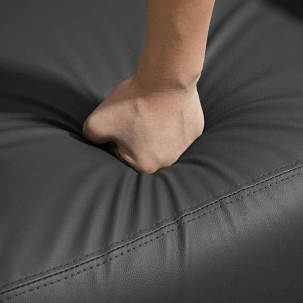 Close-up of black faux leather massage recliner seat with stitched seam