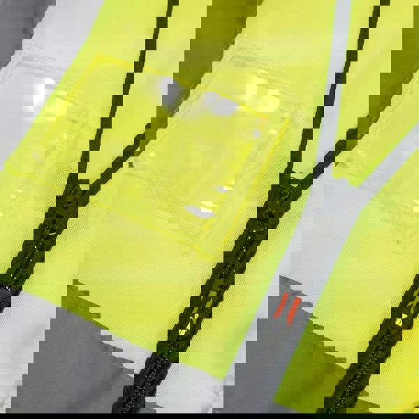 Scruffs High Visibility Mens Hi-Viz Technical Zip Up Vest, close-up of bright yellow high-visibility vest with reflective strip and front zipper pocket.