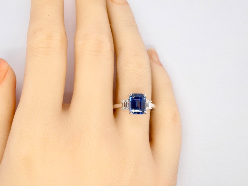 A fine three stone Sapphire and Diamond Ring finger view