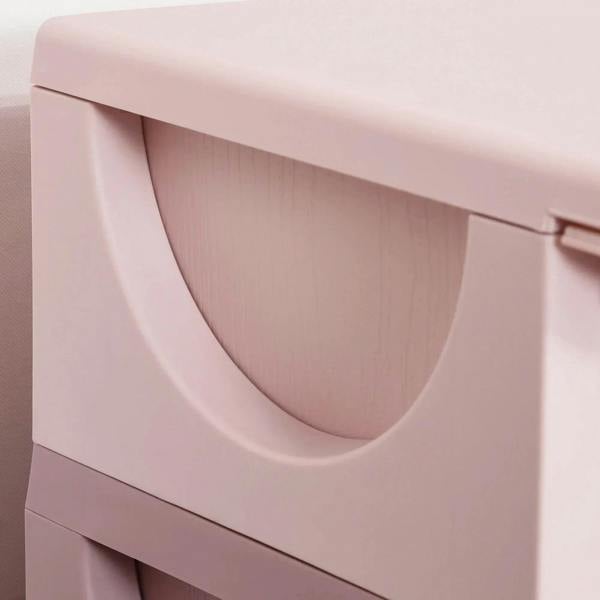 Pink plastic drawer front with large curved oval pull handle on 3-tier storage unit