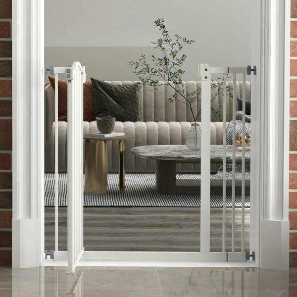White pet gate with vertical bars and latch, installed in a doorway across living room