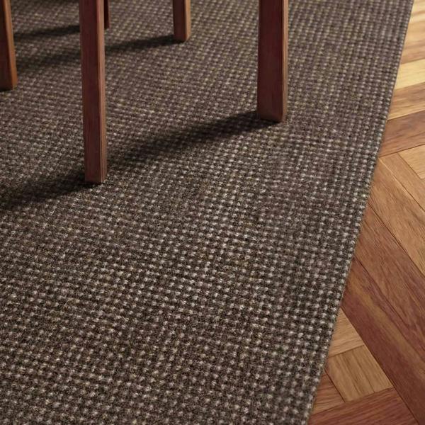 Brown textured carpet runner on a wooden floor