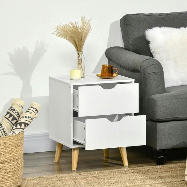 White bedside table with two drawers, curved cut-out pulls, and tapered pine legs