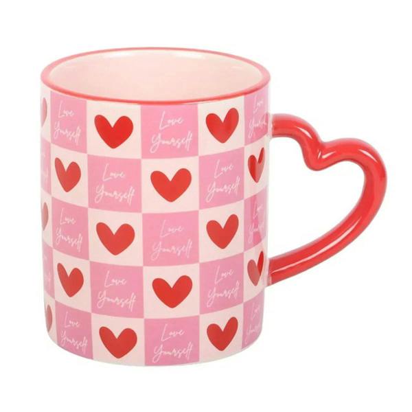 Pink checkered mug with red heart motifs and red heart-shaped handle, front view