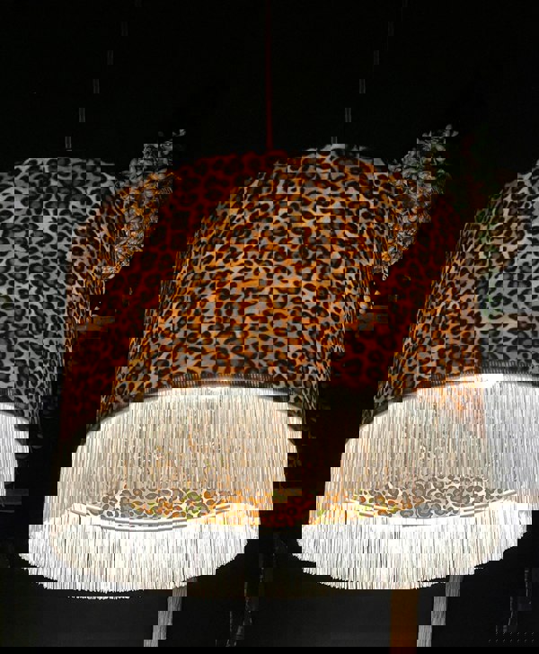 Crisp White Leopard Print Silhouette Lampshade with White Fringing with the light on