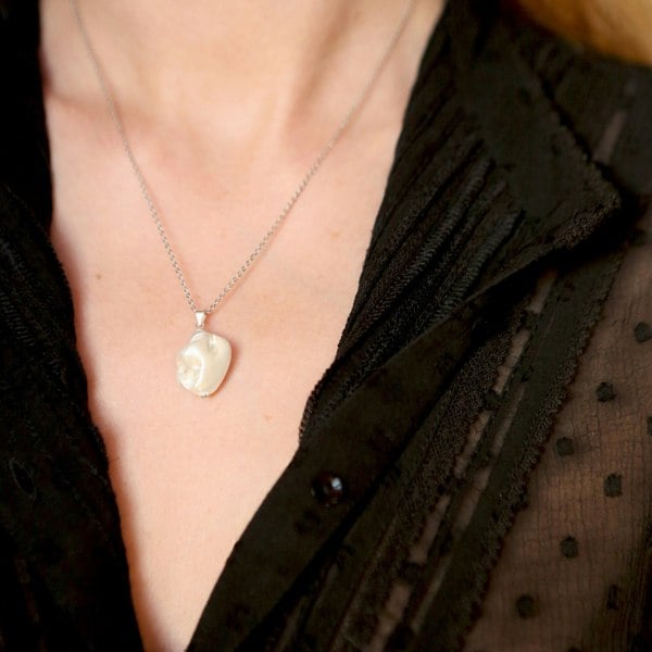 Silver electroplated shell pendant charm by LENAE, handmade in London, UK shown on a model.