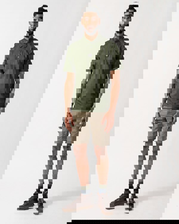 full length of a model wearing a HUGO Deabono Mens Interlock Cotton Polo Shirt with Stacked Logo in Dark Green