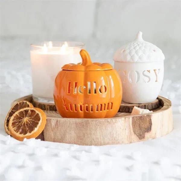 Orange pumpkin oil burner in wooden tray with lid and cutout lettering